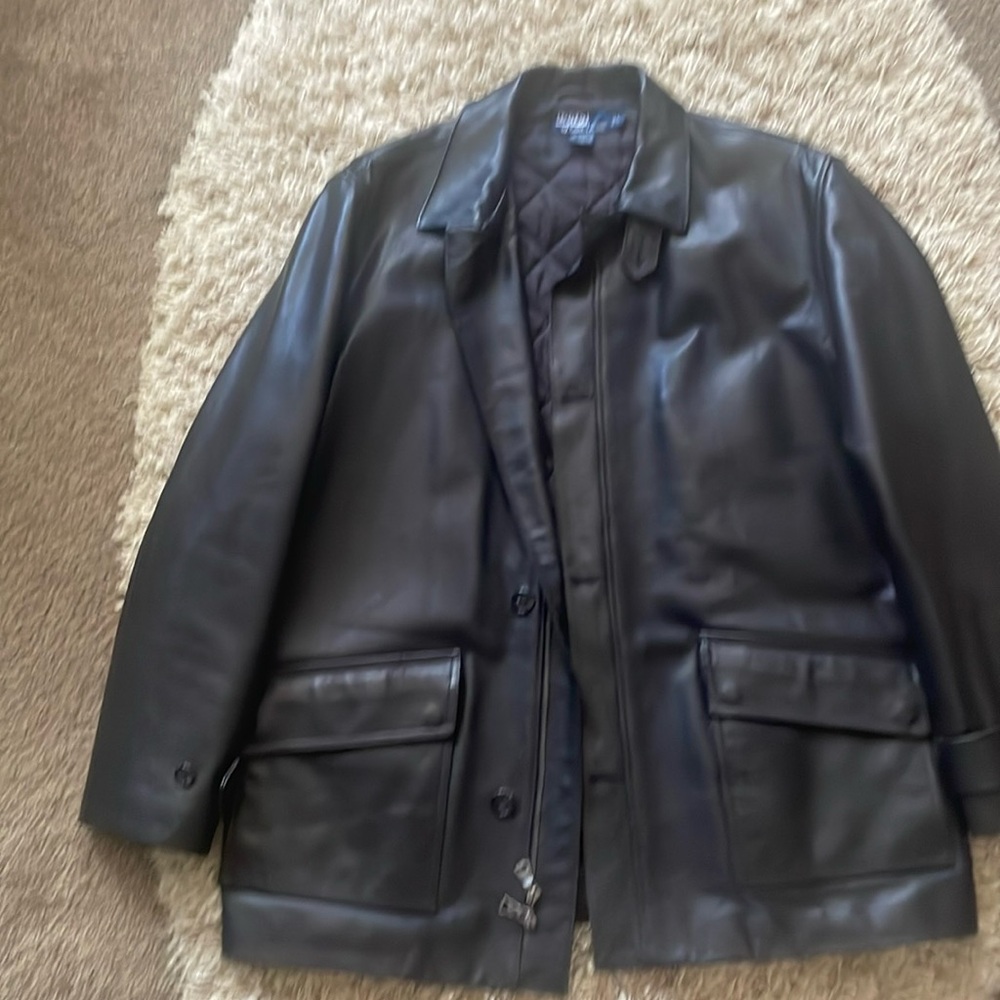 A leather Ralph Lauren Coat. It's lined, has a zipper closure/buttons, 3 pockets